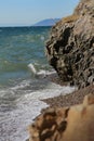 White waves beat against the sea rocks