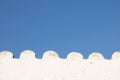 White wavy empty wall in blue sky with copy space Royalty Free Stock Photo