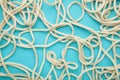 White wavy rope on blue background. Space for text Royalty Free Stock Photo