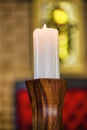 white wax candle in a wood candle holder Royalty Free Stock Photo