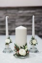 White wax candles with bouquet composition