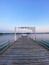 White wedding arch beautifully decorated with flowers on the bridge, pier. Adriatic coast and sea in Slovenia. Holiday, weddings Royalty Free Stock Photo