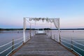 White wedding arch beautifully decorated with flowers on the bridge, pier. Adriatic coast and sea in Slovenia. Holiday, weddings Royalty Free Stock Photo