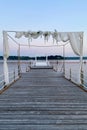 White wedding arch beautifully decorated with flowers on the bridge, pier. Adriatic coast and sea in Slovenia. Holiday, weddings Royalty Free Stock Photo