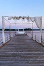 White wedding arch beautifully decorated with flowers on the bridge, pier. Adriatic coast and sea in Slovenia. Holiday, weddings Royalty Free Stock Photo