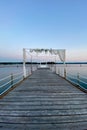 White wedding arch beautifully decorated with flowers on the bridge, pier. Adriatic coast and sea in Slovenia. Holiday, weddings Royalty Free Stock Photo