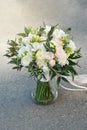 White Wedding Bouquet Roses Pink flowers and Ruscus Leaves with Robbons on Gray Asphalt Background. Wedding Decoration