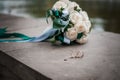 White wedding bouquey of roses and pair of wedding rings
