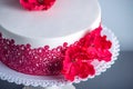 White Wedding Cake Decorated With Flowers Sugar Poppies And Red Pattern Ornament. Concept Of Elegant Holiday Desserts