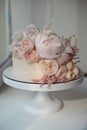 White wedding cake decorated with fresh roses, peonies and greenery Royalty Free Stock Photo