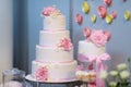 White wedding cake decorated with pink flowers