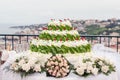 White Wedding Cake decorated with red fruit and green lemon leaf, Floreal Theme Royalty Free Stock Photo