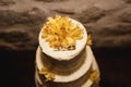 White wedding cake decorated with rings and yellow lilies. Top view Royalty Free Stock Photo