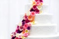 White wedding cake decorated with sugar flowers