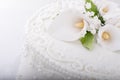 White Wedding cake detail closeup with flower, swirls, and decorative pearls Royalty Free Stock Photo