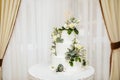 White Wedding Cake With Flowers. The Word Love With Heart.
