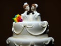 White wedding cake and gay couple on top. two grooms will marry.