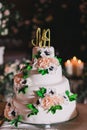 White wedding cake with mastic, decorated with roses and letters Royalty Free Stock Photo