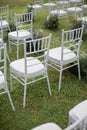 White wedding chairs on a green grass. Royalty Free Stock Photo