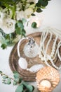 White wedding decor, perfume, pearl beads and bouquet of flowers Royalty Free Stock Photo