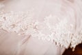 White Wedding dress on bed sheet close-up Royalty Free Stock Photo