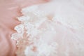 White Wedding dress on bed sheet close-up Royalty Free Stock Photo