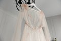 White wedding dress hanging in the bedroom. White bride dress