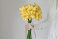 White dress woman holding yellow lily flower bouquet Royalty Free Stock Photo