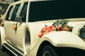 White wedding limousine decorated with flowers. Royalty Free Stock Photo