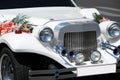 White wedding limousine with flowers Royalty Free Stock Photo