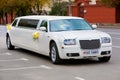 White wedding limousine on the road Royalty Free Stock Photo