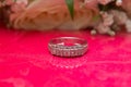 White wedding rings . flower bouquet selective focuse .Two silver wedding rings red background . Romantic and lovely wedding ,