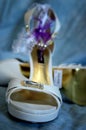 White wedding shoes and garter at the blue background Royalty Free Stock Photo