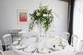 White wedding table set with a flower decoration.