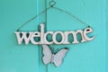 White welcome sign with a butterfly