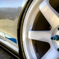 White wheel rim with metallic blue bolts of a car Royalty Free Stock Photo