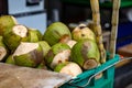 a basket filled with fresh cut coconuts sitting on a counter