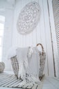 White wicker basket with gray plaids in the interior