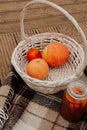 wicker basket with pumpkins and jam autumn picnic close up