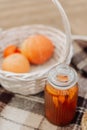 wicker basket with pumpkins and jam autumn picnic close up