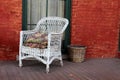 White wicker chair and red brick