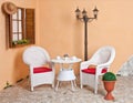 White wicker furniture Rattan European internal courtyard. Royalty Free Stock Photo