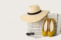 White wicker suitcase, womens hat, sunglasses, yellow shoes and Royalty Free Stock Photo