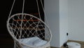 White wicker swing chair, cute interior. White bedroom, cozy house. The interior design of the nursery concept, big