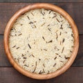 White and wild rice in wooden bowl on table Royalty Free Stock Photo