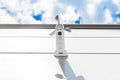 White wind speed sensor, on the wall building sky background. Vane anemometer Royalty Free Stock Photo