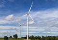 White wind turbines generating electricity in wind power station alternative renewable energy from nature