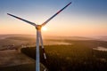 White windmill closeup at sunrise, sun rays flooding around and making mist, pink sky background Royalty Free Stock Photo