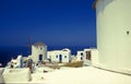 White windmill and houses in Oia on volcanic island of Santorini
