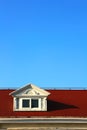 The white window of the loft on the red roof Royalty Free Stock Photo